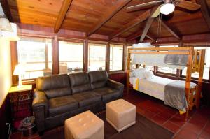 a living room with a couch and a bed at The Cabin at Deer Hollow in Three Rivers