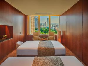 a hotel room with two beds and a window at Hyatt Regency Tokyo in Tokyo