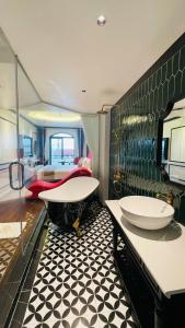a bathroom with two sinks and a bath tub at Glory Hotel Vĩnh Yên in Nhân Mỹ +141 photos