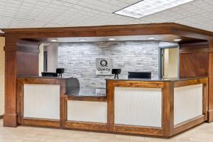 a lobby with a waiting area with a stone wall at Quality Inn & Suites Florence Civic Center in Florence