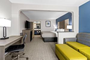 a hotel room with a bed and a desk at Quality Inn & Suites Florence Civic Center in Florence