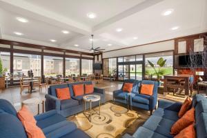 a living room with blue couches and orange pillows at Quality Inn & Suites Chattanooga-East Ridge in Chattanooga