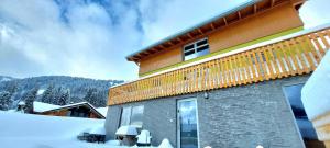 a building with snow in front of it at Ferienwohnung Sonnenschein in Balderschwang