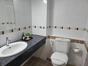 a bathroom with a white toilet and a sink at Sena House in Bangkok +32 photos