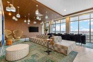 a conference room with a table and chairs and a television at Cambria Hotel Ocean City - Bayfront in Ocean City