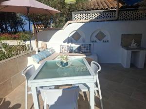 a white table and chairs on a patio at Piccula Casa in Albitreccia