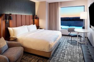 a hotel room with a bed and a window at Tempo By Hilton Manassas in Manassas