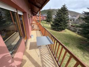 a table on the balcony of a house at Apartament la Llúdriga in Llivia