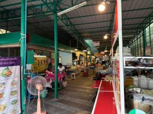 an indoor market with a person in the background at S Hostel Sukhumvit 48 in Bangkok