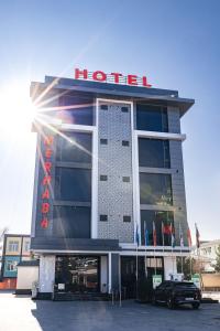 a hotel with a car parked in front of it at Merhaba Hotel, Fergana in Fergana