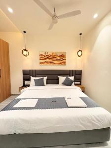 a bedroom with a large bed with two lights at Hotel Moti Mahal in Ambikāpur