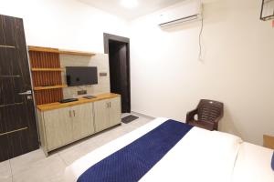 a bedroom with a bed and a tv in it at Hotel Carnival in Bāghpat +4 photos