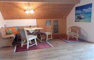 a living room with a table and chairs and a couch at Ferienwohnung Lechauszeit in Landsberg am Lech