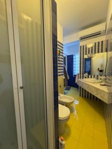 a bathroom with two toilets and a sink and a tub at Dejavu ROOMS & SPA in Assoro +24 photos
