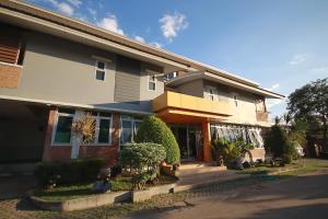 a large house with a building at 100House Hotel Korat in Ban Hua La Loeng
