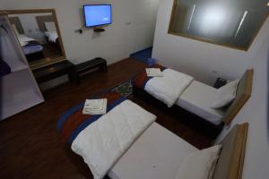 a small room with a bed and a mirror at Hotel Latso Ladakh in Leh +11 photos