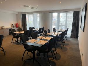a conference room with tables and chairs and windows at Cityloft 147 in Istanbul