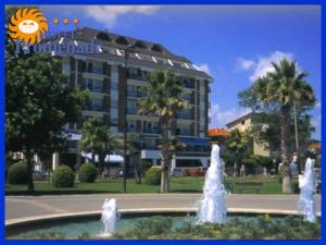 a hotel with a fountain in front of a building at Hotel Promenade in Porto SantʼElpidio