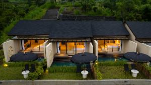 an aerial view of a house with umbrellas at Mount Valley Inn in Kubupenlokan