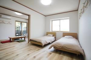 a bedroom with two beds and a mirror at レインボーマリン in Mihama