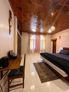 a bedroom with a bed and a wooden ceiling at Yogstel - Backpackers Hostel in Dūta