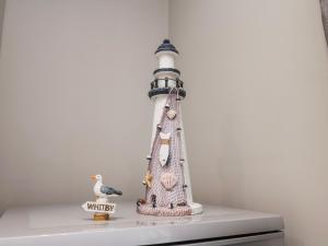 a figurine of a lighthouse sitting on a shelf at Brinkleys Nook in Whitby +21 photos
