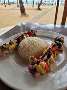 a plate of food with rice on a table at Galaxy Lounge in Arugam Bay +32 photos