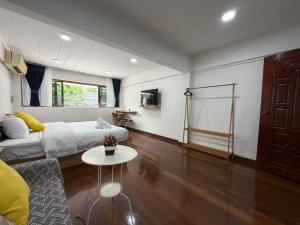 a living room with a couch and a table at S Hostel Sukhumvit 48 in Bangkok