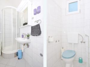 two images of a bathroom with a toilet and a sink at Apartment T&M in Trogir +64 photos