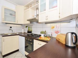 a kitchen with white cabinets and a counter top at Apartment T&M in Trogir