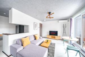 a living room with a couch and a table at Hills Niseko 206 in Wada