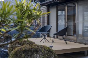 two chairs sitting on a patio in a building at MITAMA House 01 ミタマ ハウス 01 in Ise