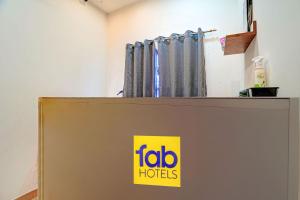a sign on top of a door with a fotolords sign on it at FabHotel Gold Residency in Chennai