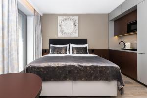 a bedroom with a large bed and a table at Hotel Awam in Hradec Králové