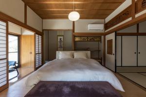 a bedroom with a large bed in a room at MITAMA House 01 ミタマ ハウス 01 in Ise
