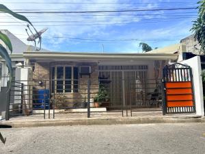 a house with a gate in front of it at BMF Tropical Homestay in Calampanan