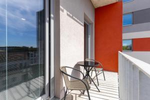 a balcony with two chairs and a table at Hotel Awam in Hradec Králové