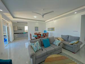 a living room with a couch and a table at Aqua seaside Apartments in Mombasa