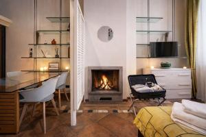 a living room with a desk and a fireplace at Vittoria Residence Spanish Steps in Rome