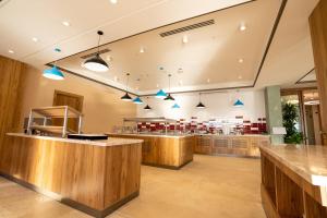 a restaurant with wooden counters and blue lights at Zafaron Premium Hotel in Chimgan +253 photos