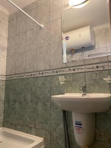 a bathroom with a sink and a mirror and a toilet at Stylish, 1-Bedroom at Watermill Complex in Bŭnzareto +12 photos