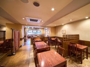 a dining room with wooden tables and chairs at Hotel Pearl City Morioka in Morioka +36 photos