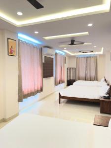 a bedroom with a large bed in a room at Bhavya Guest House in Rīngas