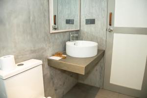 a bathroom with a sink and a toilet at KAHA by TONIK, Talpe - Pool & Garden in Talpe +27 photos