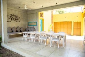 a dining room with a table and chairs at KAHA by TONIK, Talpe - Pool & Garden in Talpe