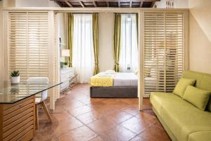 a bedroom with a bed and a couch in a room at Vittoria Residence Spanish Steps in Rome