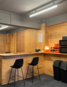 two chairs sitting at a counter in a room at The loft 6 in Busan