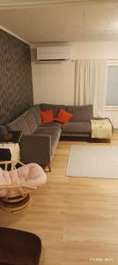a living room with a couch and a table at Veteli in Veteli
