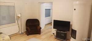 a living room with a chair and a television at Veteli in Veteli