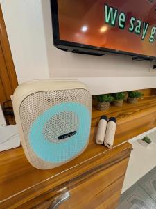 a television and speakers sitting on a shelf at BMF Tropical Homestay in Calampanan